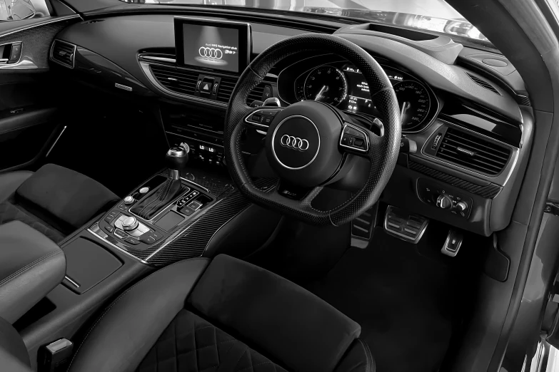 an audi vehicle with the dashboard up and all black leather