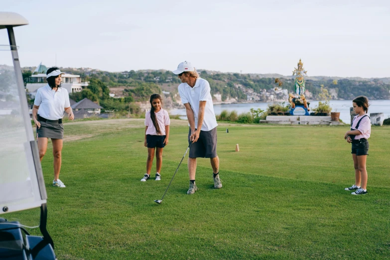 three people in white shirts are playing golf with other people