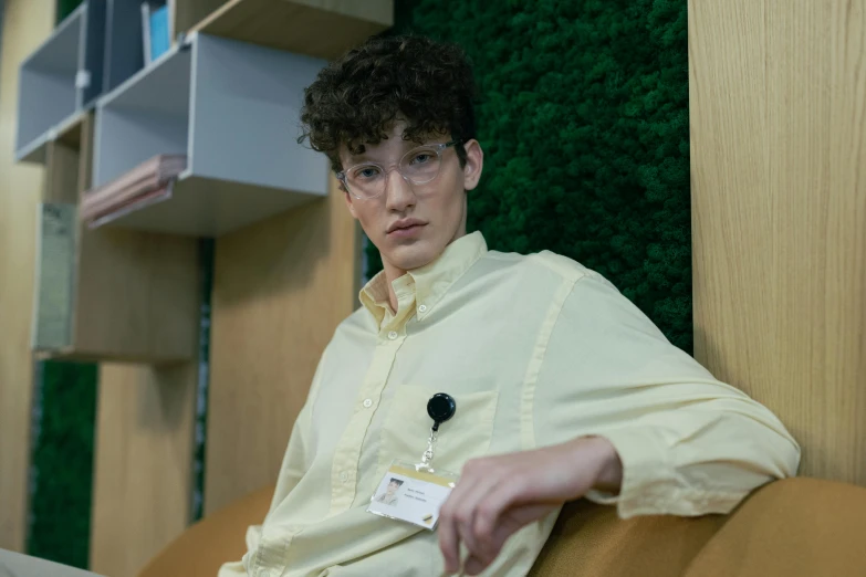 a person with a white and brown shirt is on a couch