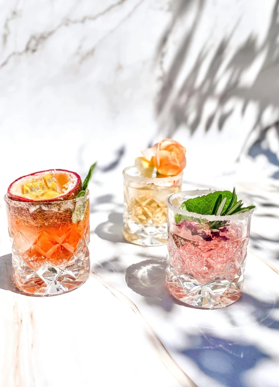 some cocktails sitting on a table on the snow