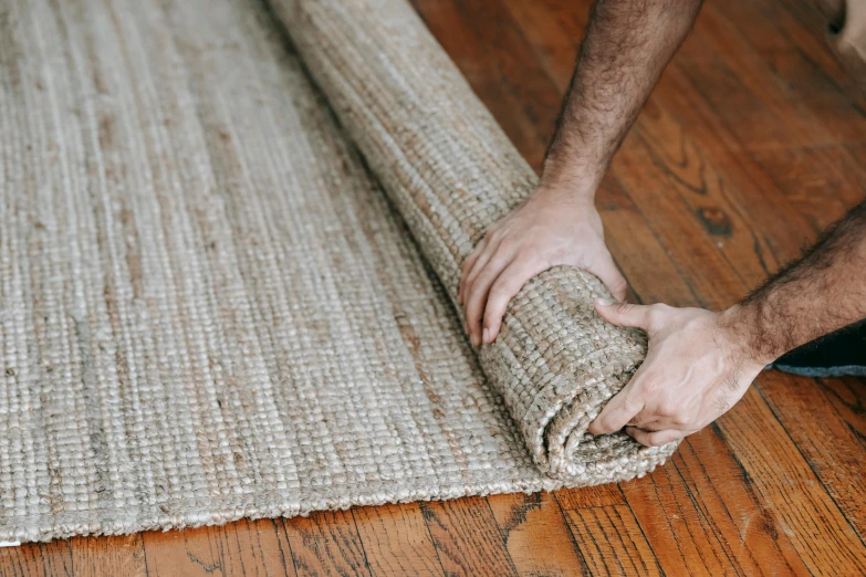 a man laying on the ground with an area rug