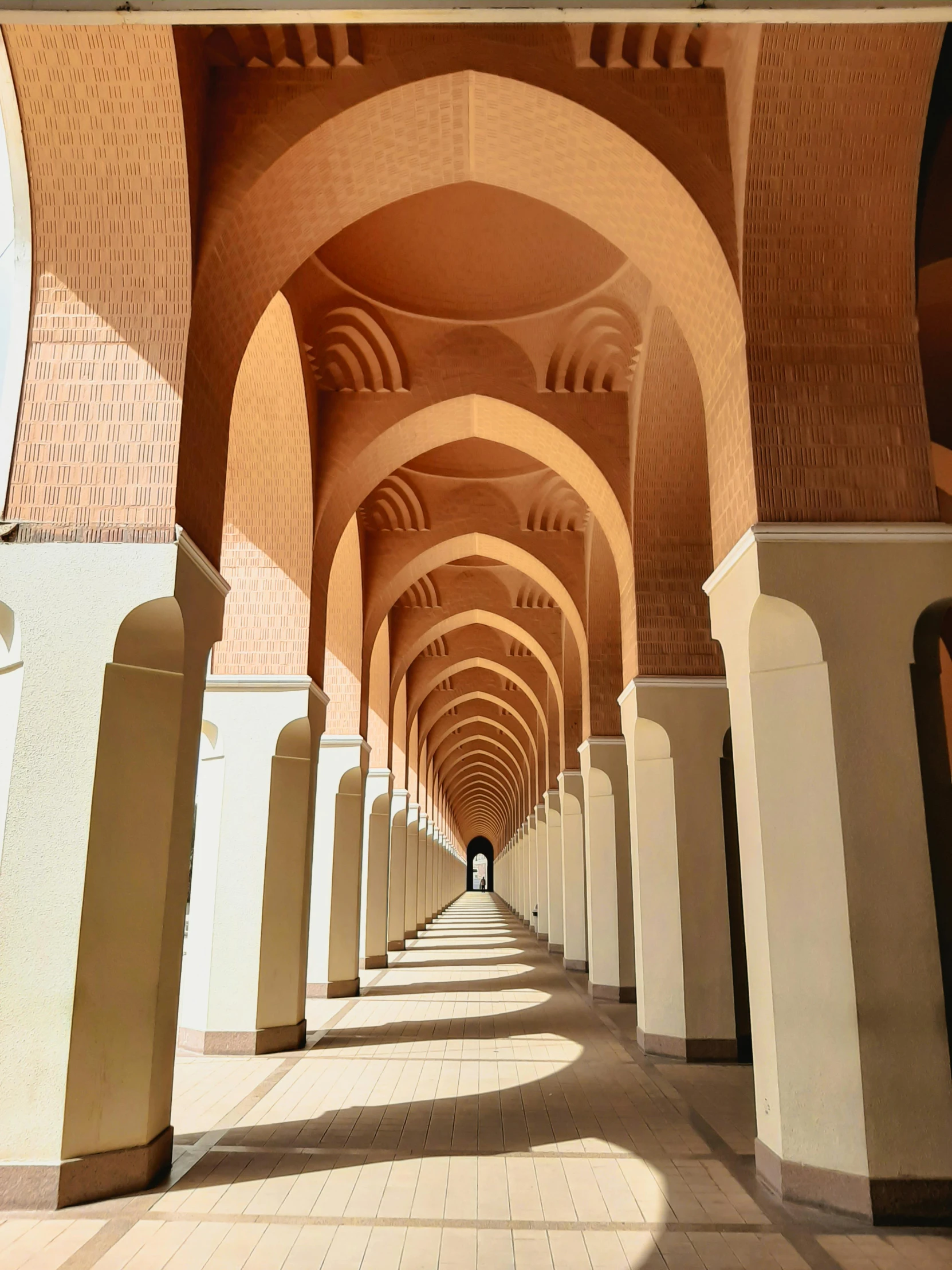 arched passageways and brickwork lines a public area in kuwait