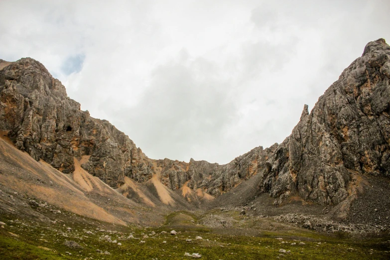 large rocks in the middle of green mountains