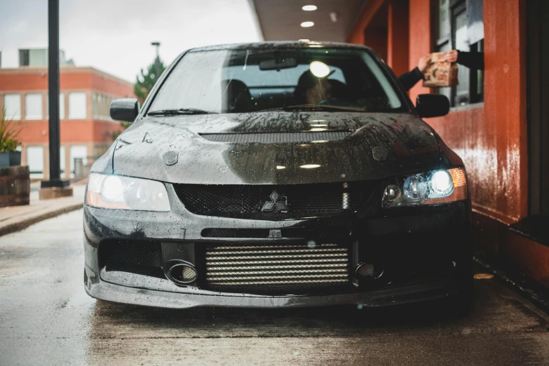 a damaged car is parked by a shop