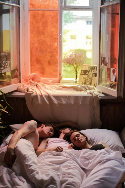 a man and woman laying in bed next to each other