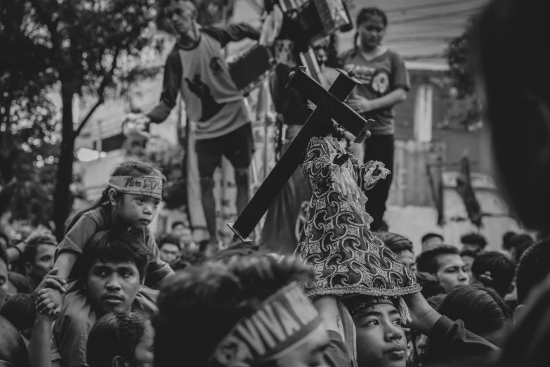 a woman holding a child on her shoulders