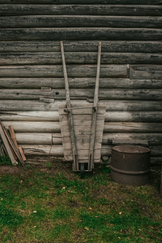 a wooden wall and some barrels in front of it