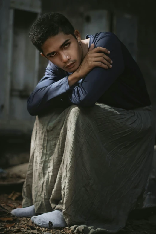 a man poses with his arm wrapped around his head