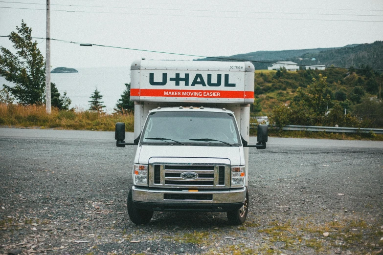 there is a truck parked on the gravel road