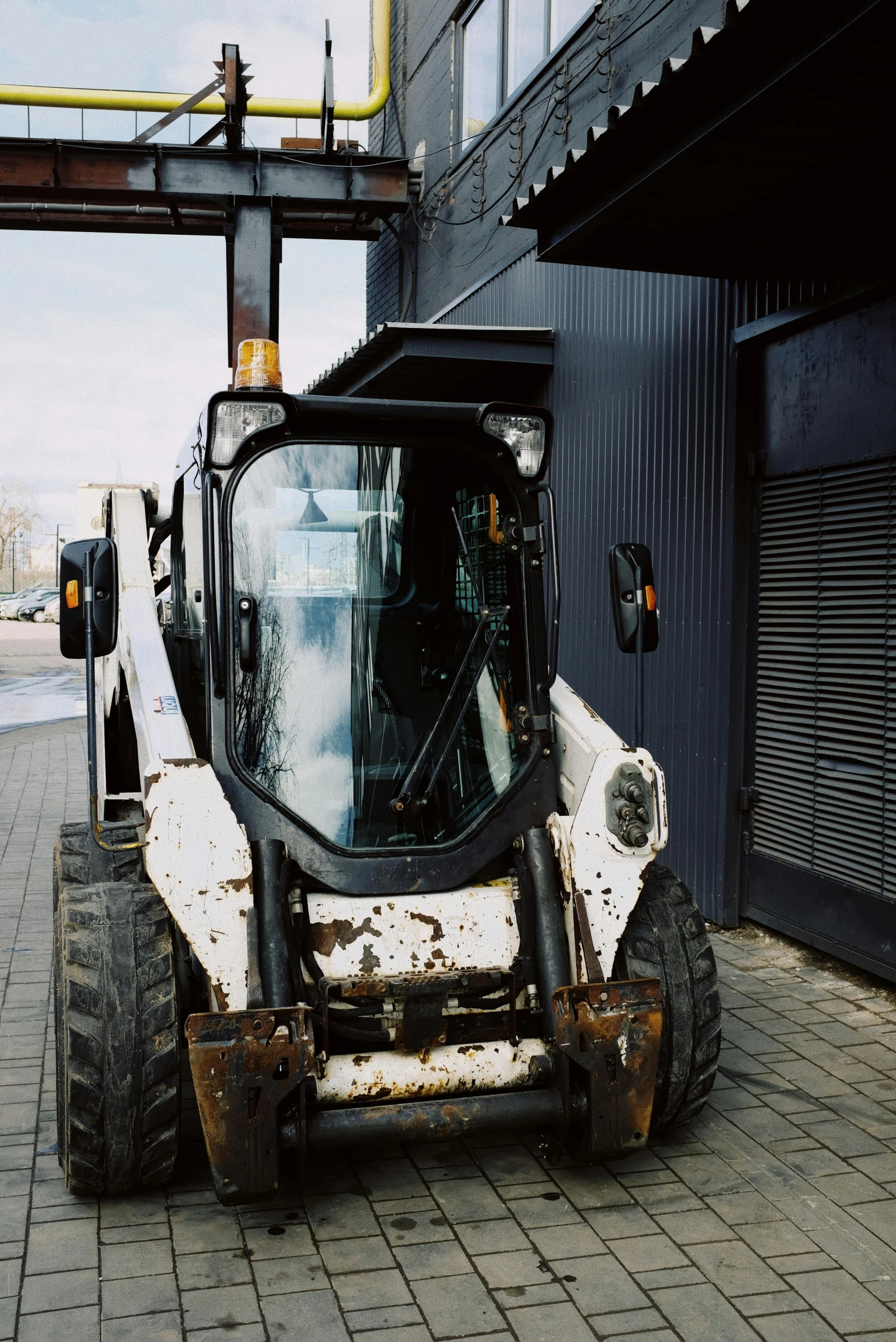 a construction equipment sits abandoned on the side of a road