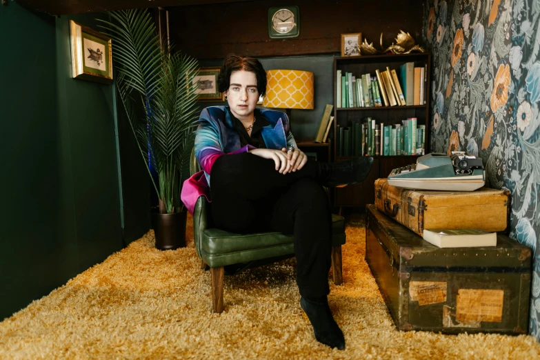 the woman is sitting in her book shelf while looking into the camera