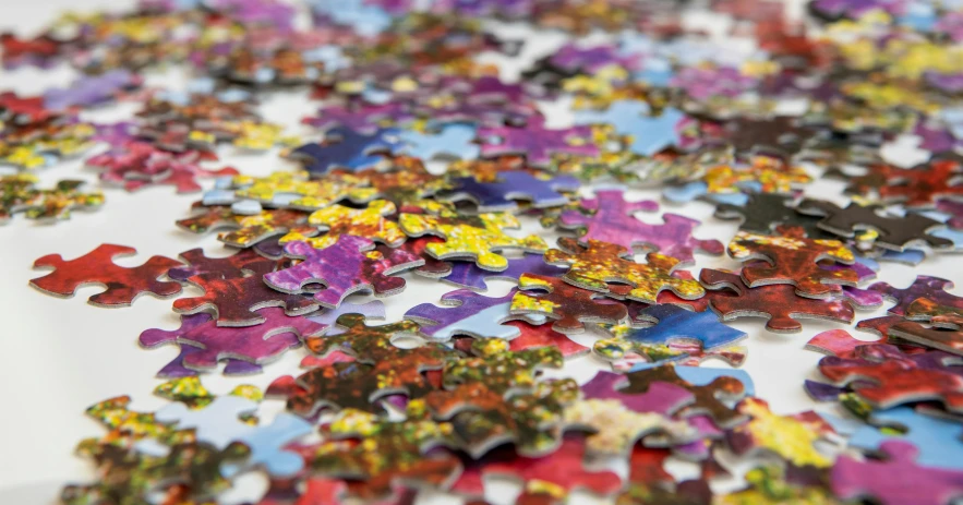 an image of colorful pieces of puzzles on the table