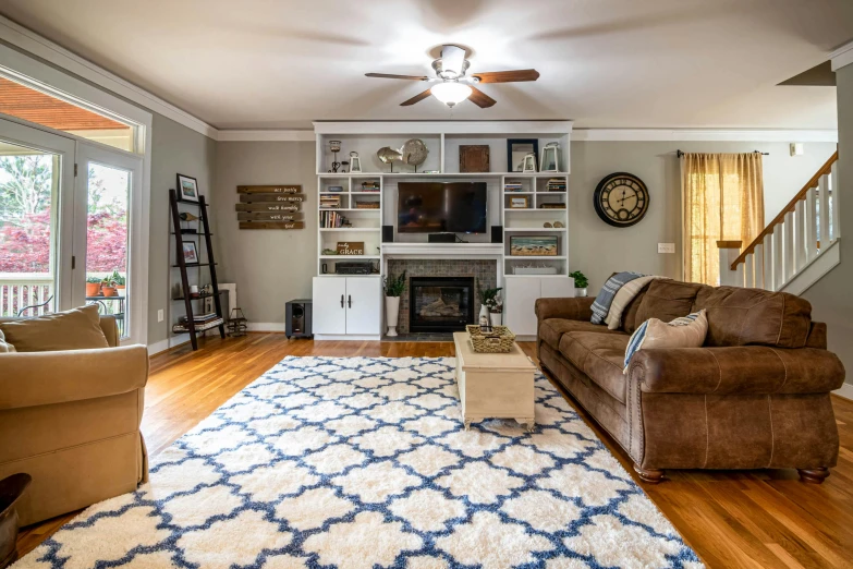 a living room with wood floors and a brown couch