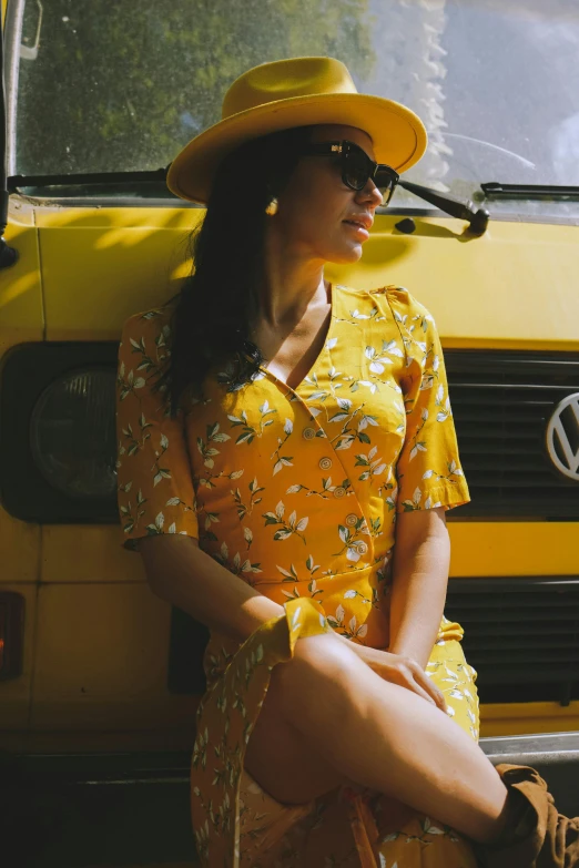 a woman sitting on the steps of a bus