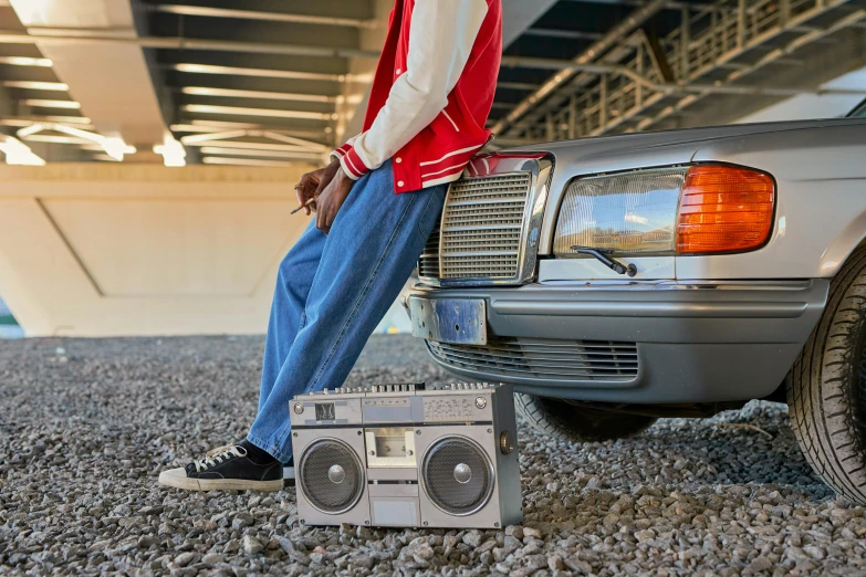 a man standing on the front of a truck by a radio