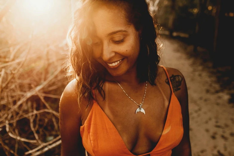 a close up of a person wearing an orange shirt smiling