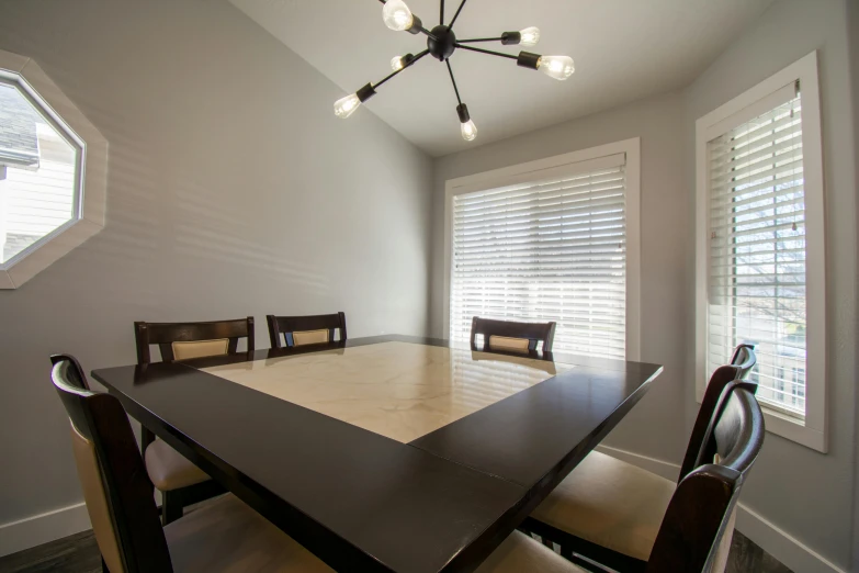 a large black table and chair sitting inside of a room