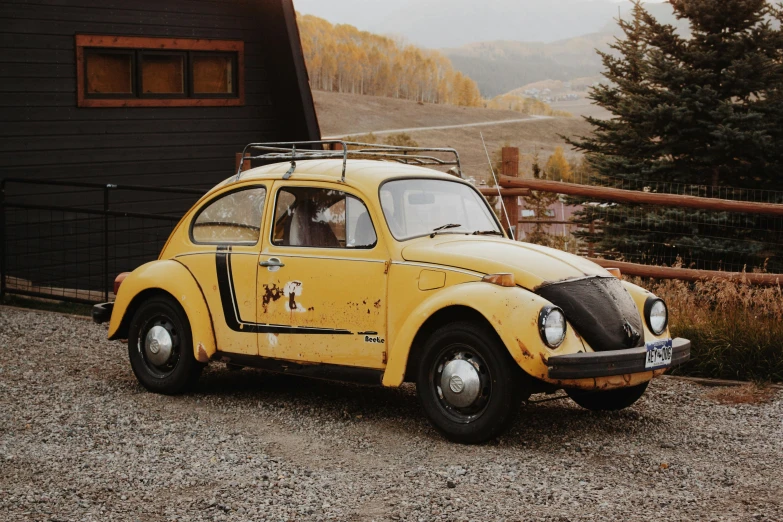 an old fashioned car is parked near the fence