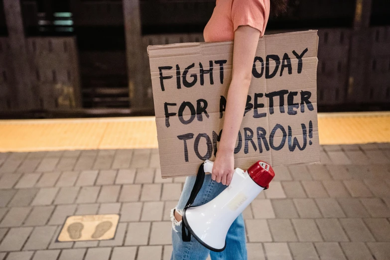 a boy holding a megaphone and a sign