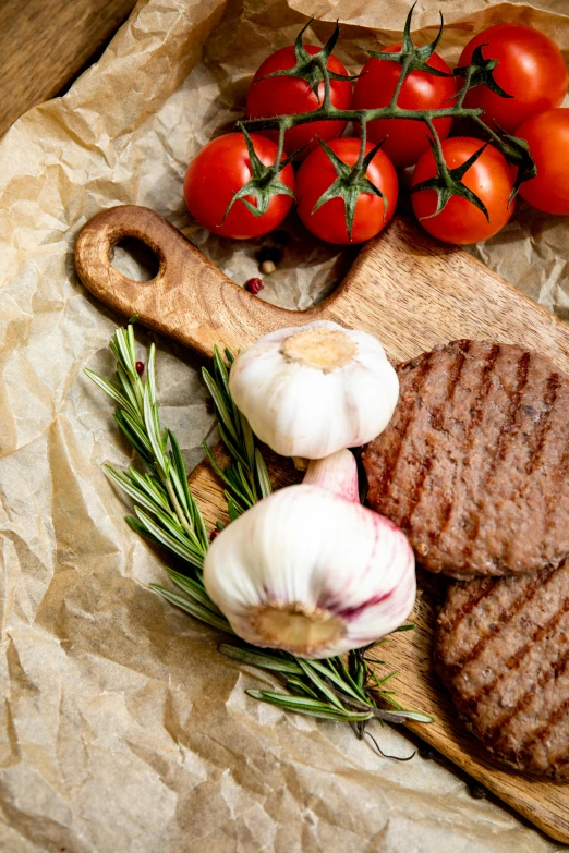 a steak, onion and tomato salad on a  board