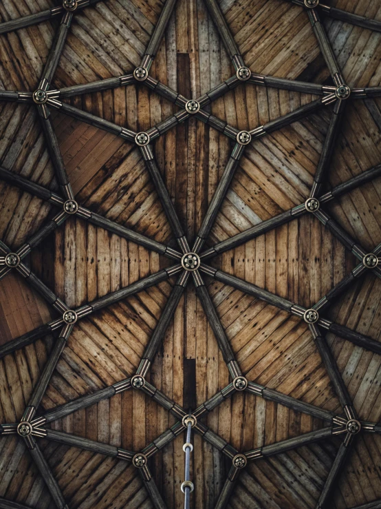 a ceiling with wooden beams and ropes and wood