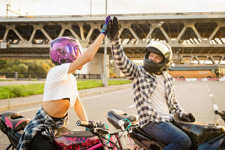 two people riding motorcycles on a city street