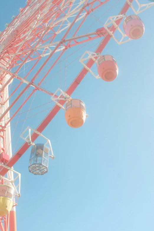 several colorful carnival rides against a blue sky