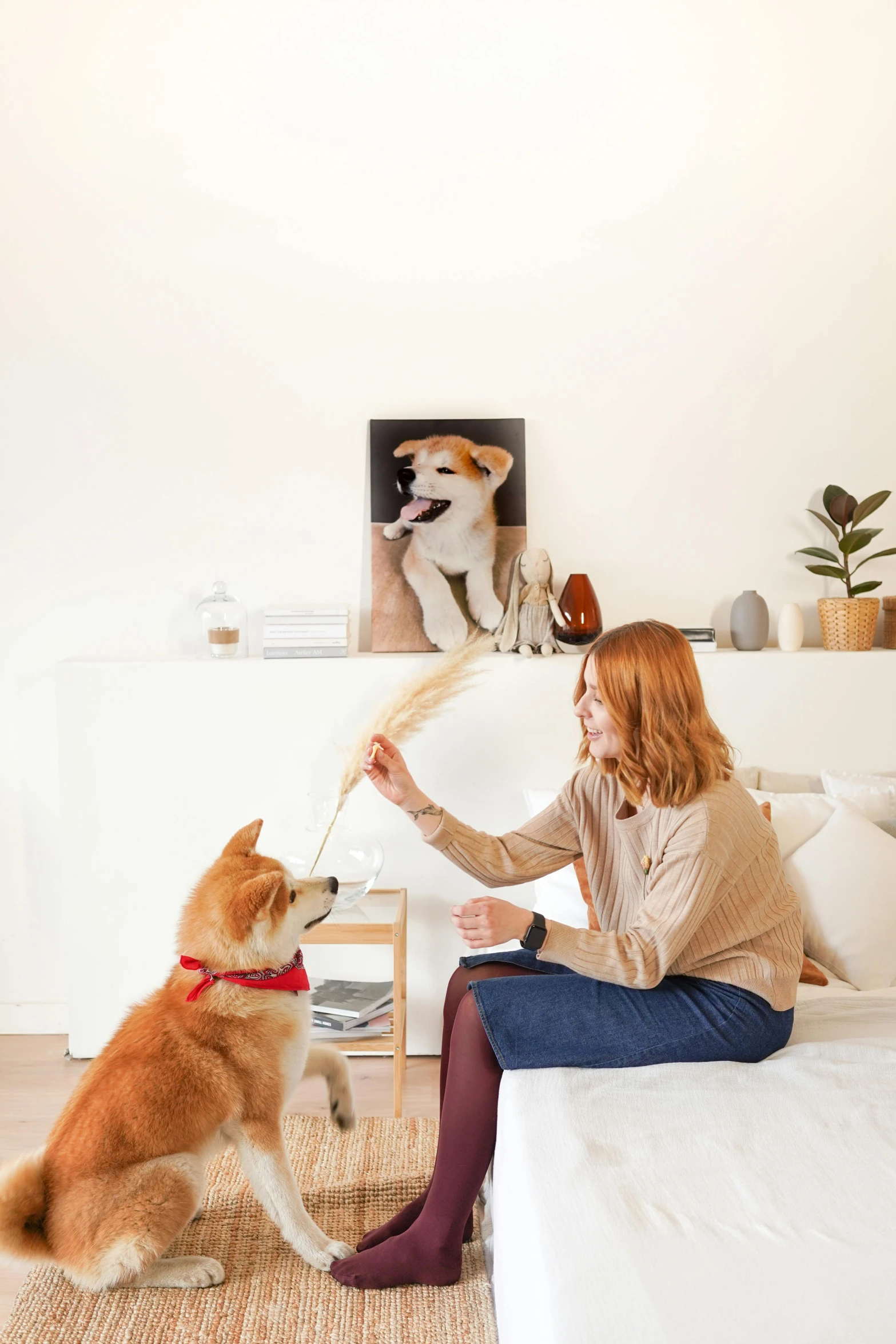 a woman that is kneeling down with a dog