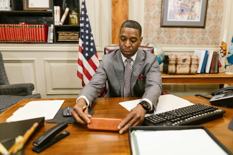 an african american businessman sitting at his desk