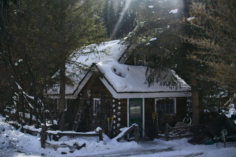 a log cabin with snow on the roof