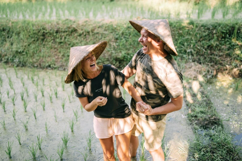 two people with hats walking along the road