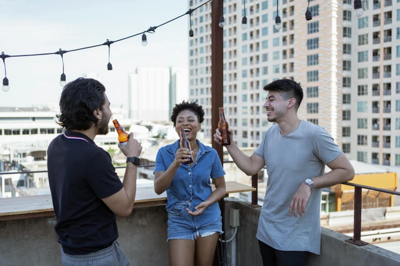 two men and a woman are drinking beer together