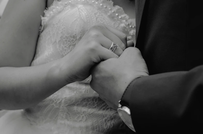 an older couple holding hands with ring on hand