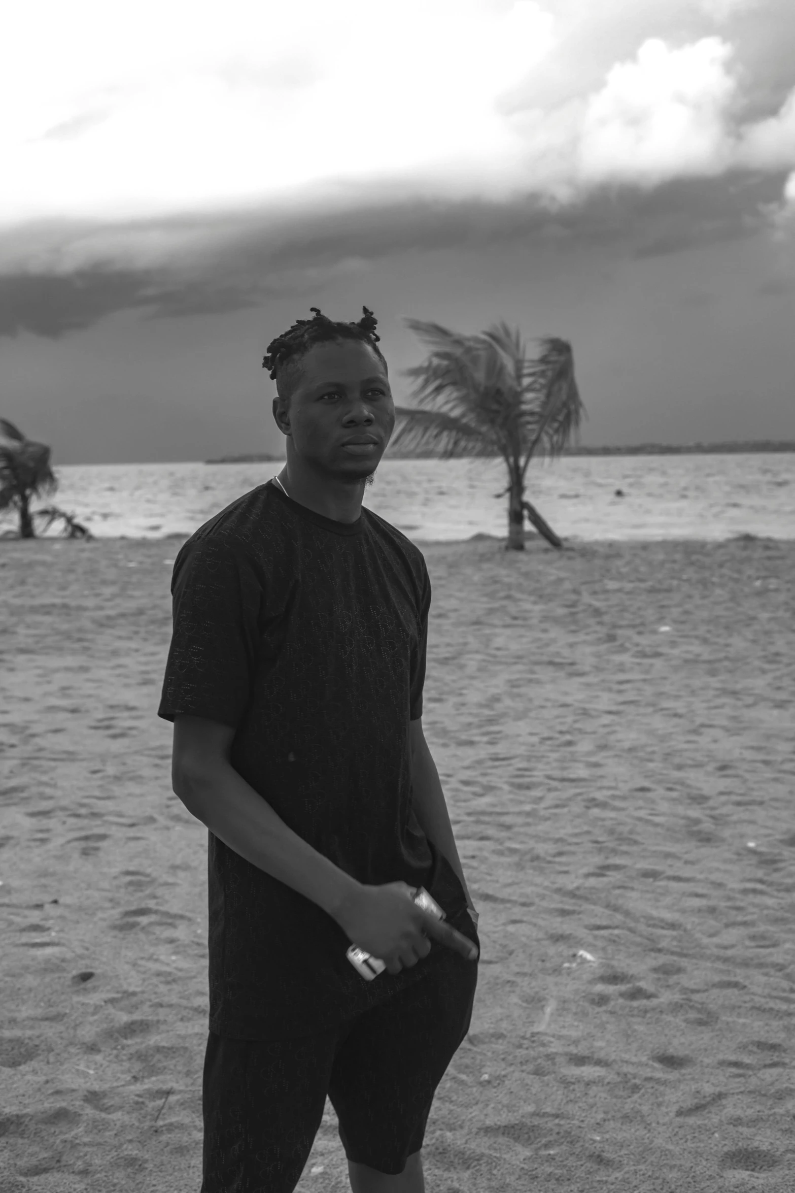 a man with a frisbee stands on a beach