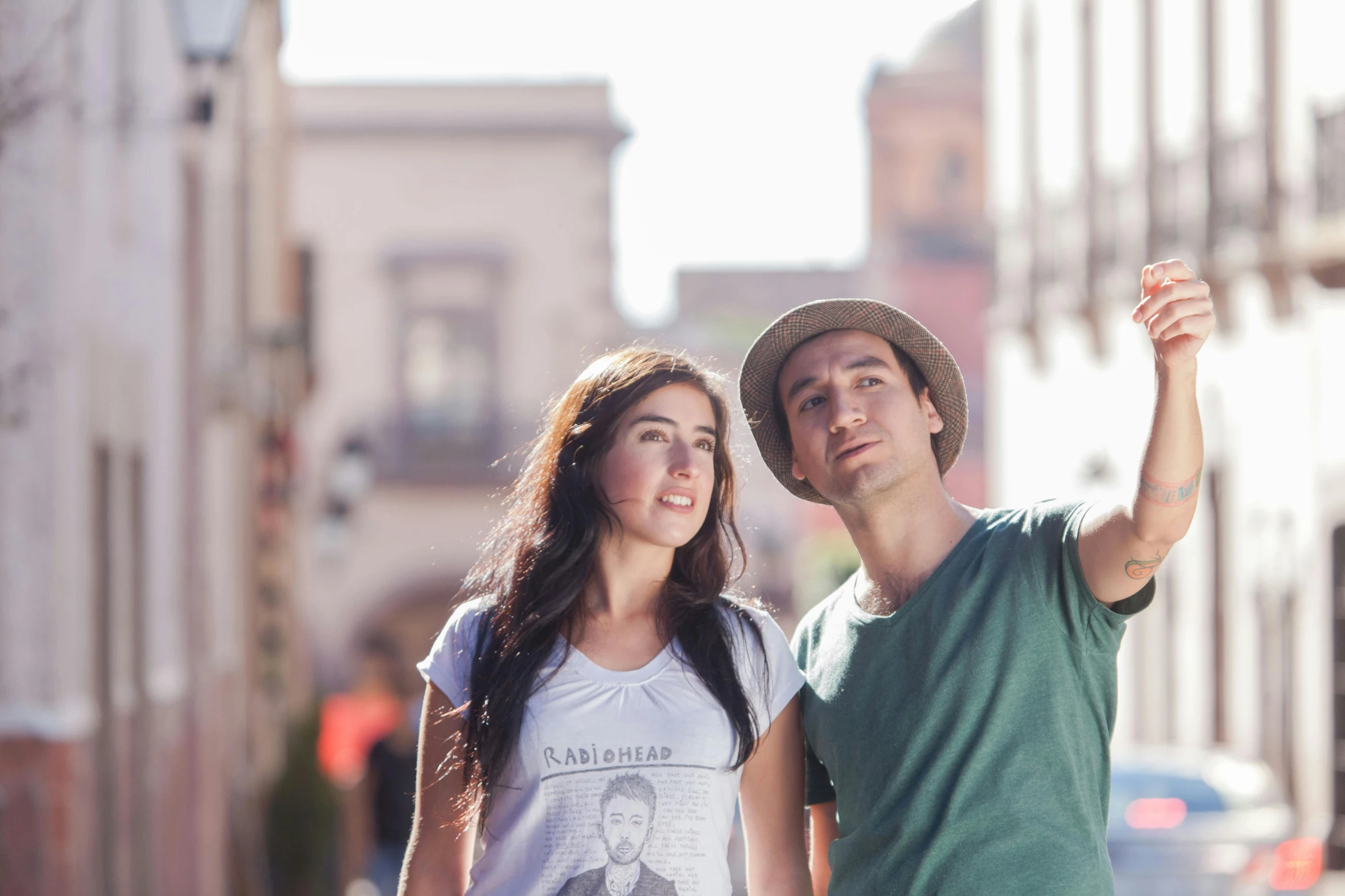 a man and woman pose in a street