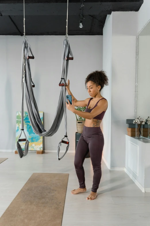 a woman in a gym holding up a loop