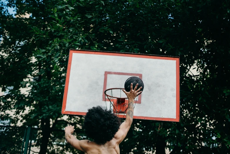 a man shooting the basketball towards the basket