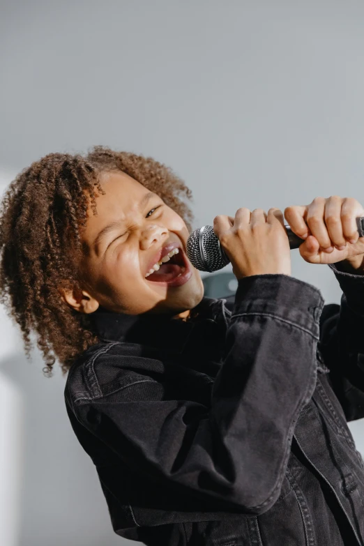 a  singing into a microphone