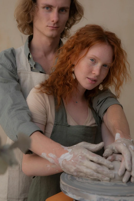 a man and a woman washing hands on a pedestal