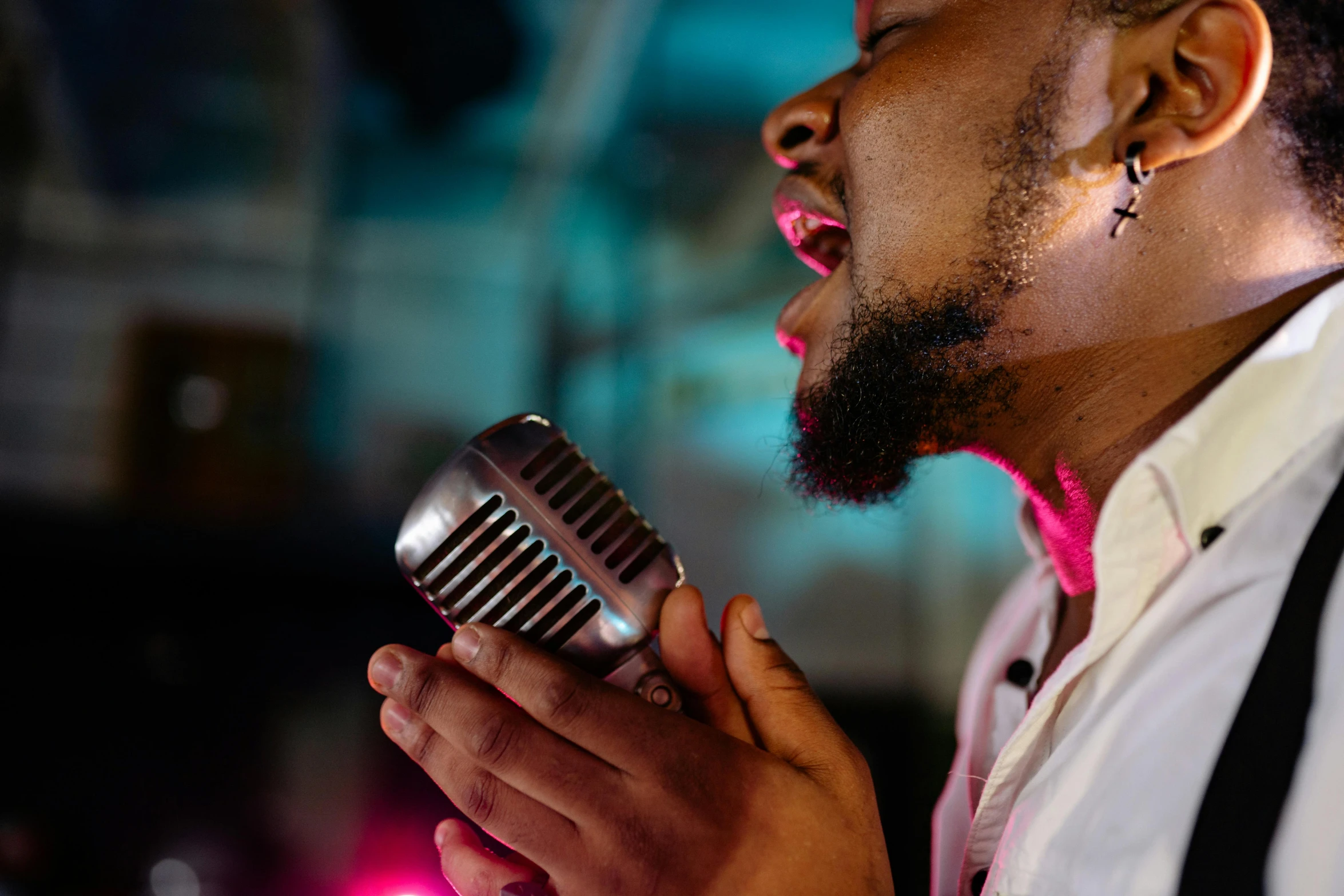 a close up of a person holding a microphone