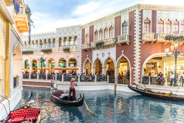 several gondolas floating in the water outside a building