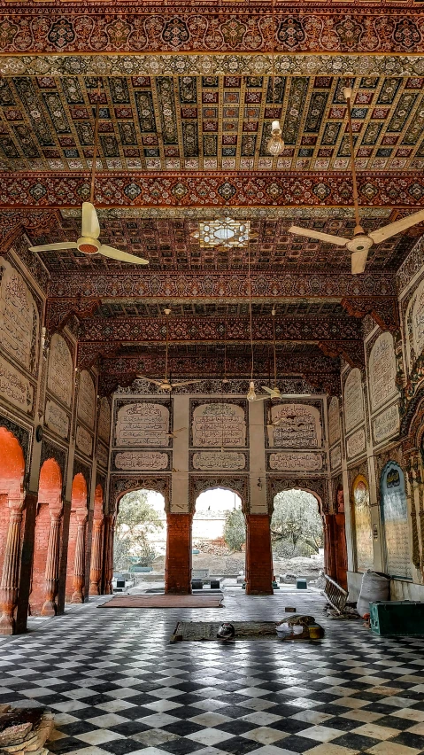 the interior of an old building with checkered flooring and a ceiling