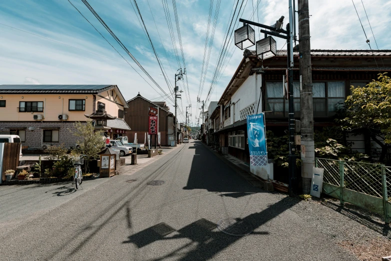 electrical wires run down a narrow city street