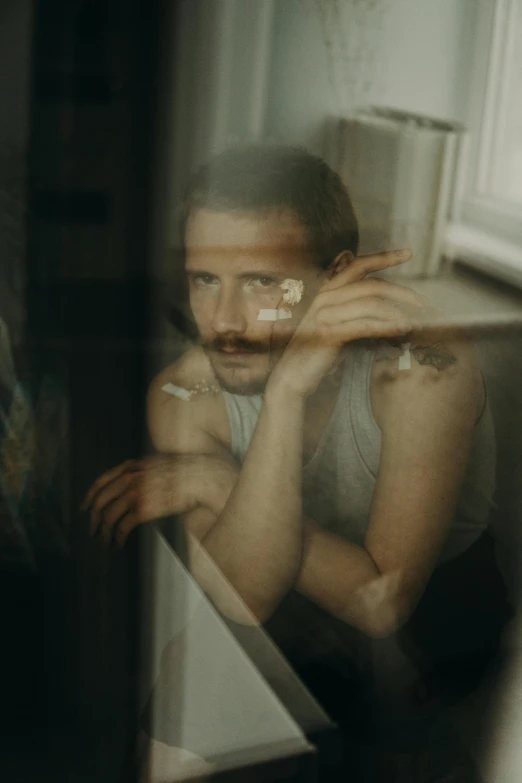 a blurry image of a man leaning up against a counter