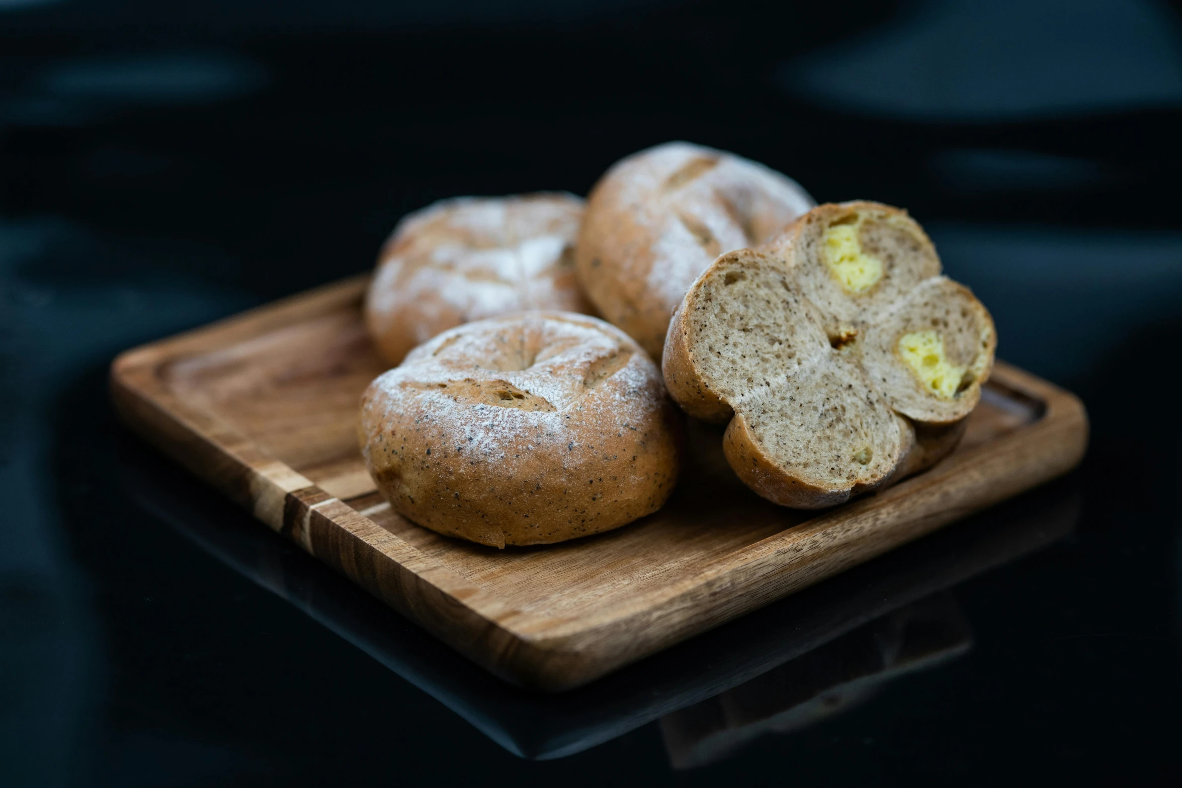 bagels sitting on a  board, on a table