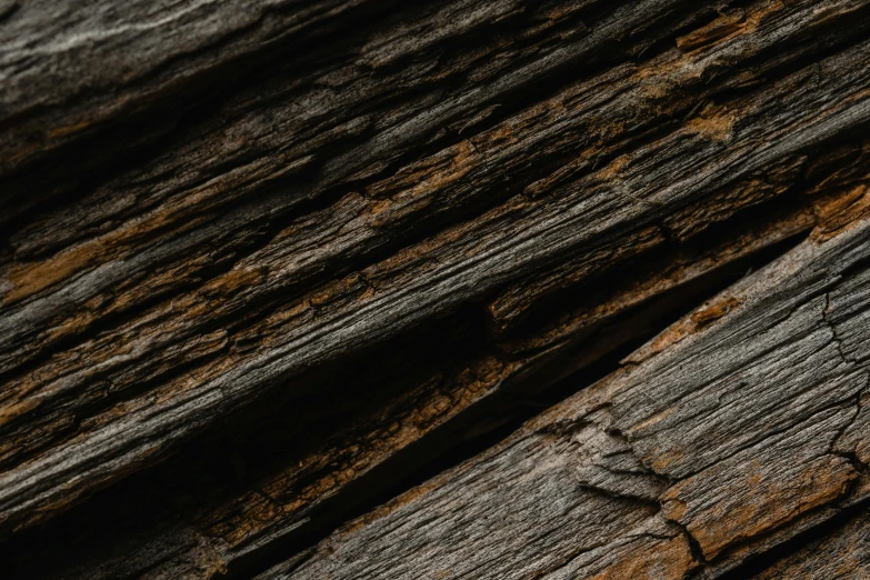 a clock mounted to the side of a wooden plank