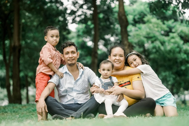 family posing for a po in the park