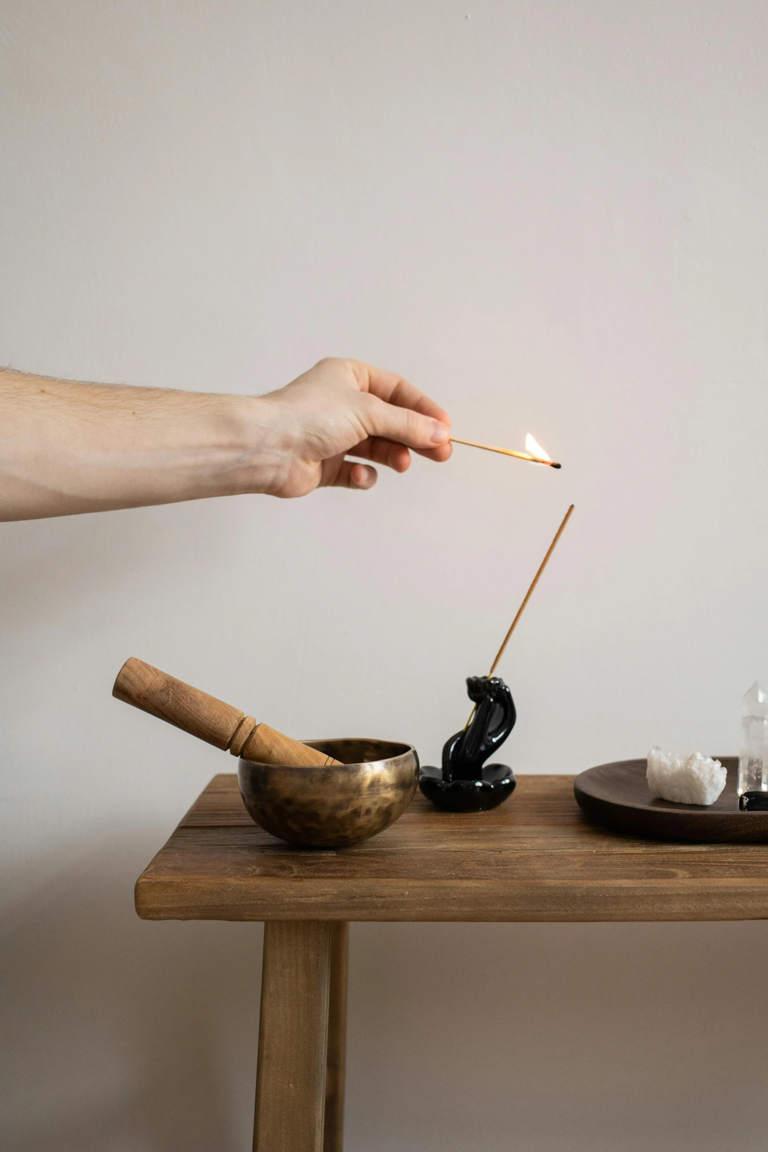 a person is smoking with a wooden stick in hand