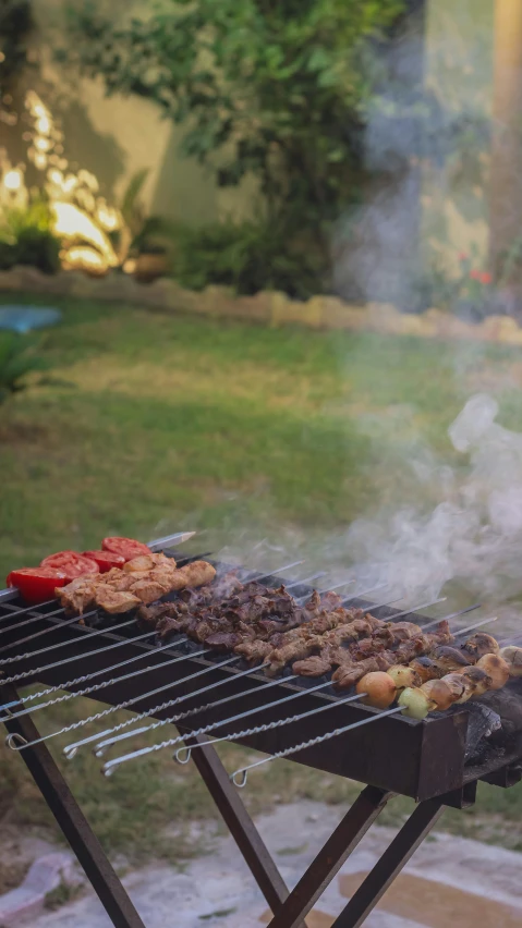 a  grill is full with different types of meats and vegetables