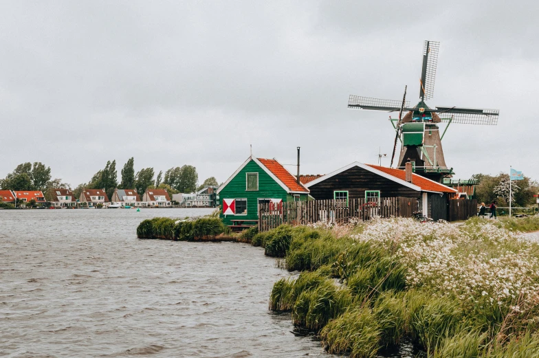 windmills and other buildings near the water